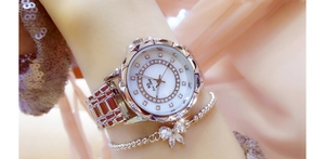 Close-up of a silver rhinestone ladies' watch and matching bow bracelet on a model's wrist