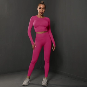 Detail of rose pink seamless yoga set featuring thumb hole cuffs and high waist leggings