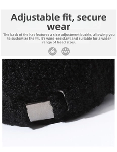 Detail of adjustable silver metal buckle on black faux fur winter baseball cap