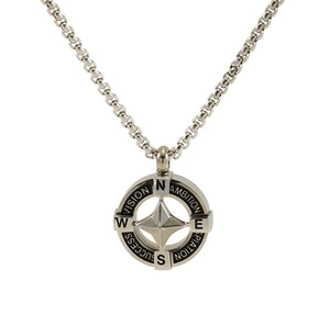Close-up of compass pendant with engraved ambition and vision words on steel chain