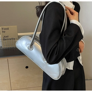 Silver metallic shoulder bag shown on model with smooth glossy faux leather texture