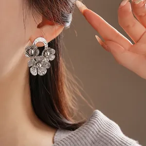 Elegant silver wrinkled floral stud earrings with vintage hammered texture for women