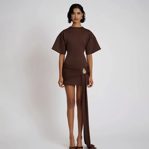 Detail of elegant brown mini dress with pleated waist, decorative buckle and long sash