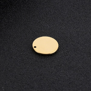 Detailed close-up of a polished gold stainless steel round charm pendant with a hanging hole
