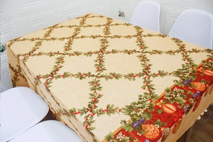 Detail of Christmas tablecloth with holly berries pattern and red decorative border