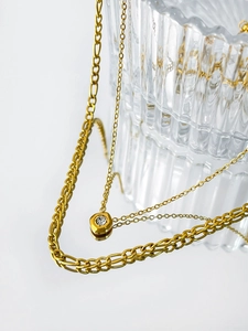 Detail of 18K gold titanium steel Figaro chain with hexagonal zircon pendant necklace