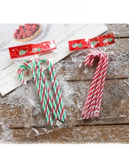 Close-up of plastic candy cane ornaments in festive red, white and green stripes