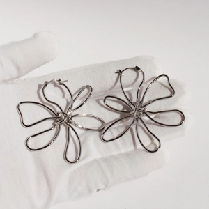 Exaggerated silver metallic flower earrings with minimalist 3D artistic floral design