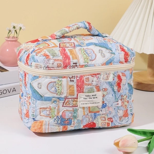Detailed macro view of quilted cotton cosmetic bag with urban house pattern and top handle