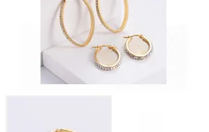 Detail of gold egg-shaped hoop earrings with pave-set white cubic zirconia stones