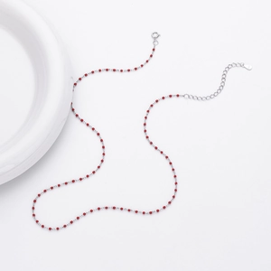 Detail of S925 sterling silver chain with red beads showing the hallmark tag