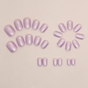 Short aurora purple press-on nails with shimmering cat-eye finish on pink background