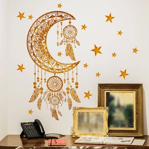 Golden glitter moon and dreamcatcher wall stickers set on white wall in cozy room