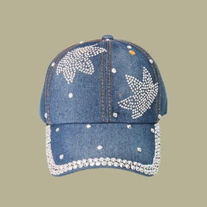 Detailed macro view of denim fabric texture with silver star rhinestones and cone studs