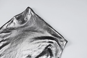 Close-up of metallic silver fabric showing shimmering texture and fine stitching detail