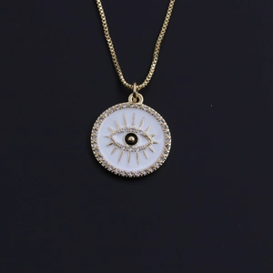 Macro view of gold plated evil eye pendant with sparkling crystals on a sleek box chain