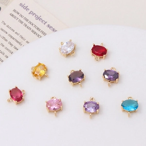 Detailed set of oval crystal glass charms with gold plated frames and dual loops for DIY jewelry