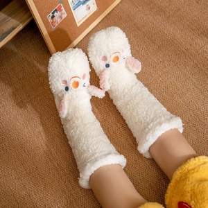 Cosy white coral fleece slippers socks with cute animal design on a textured rug