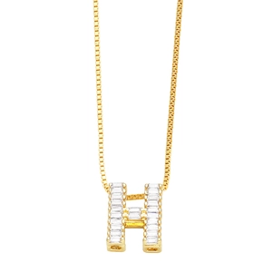 Macro detail of gold-plated letter H pendant with baguette cubic zirconia stones