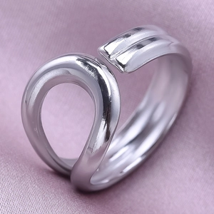 Macro shot of silver adjustable 304 stainless steel ring on purple silk fabric