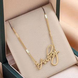 Custom gold plated stainless steel Audrey name necklace presented in a luxury gift box