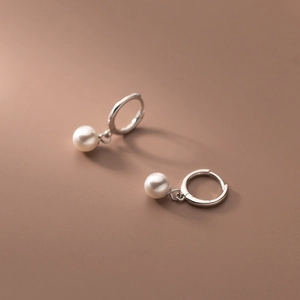 Minimalist stainless steel huggie earrings with round white pearls for women