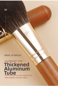 Detail of thickened gold aluminum tube and natural wood handle of makeup brush