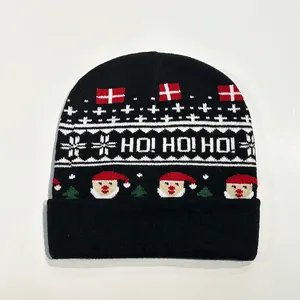 Close-up of black Christmas beanie showing HO HO HO text and festive jacquard patterns
