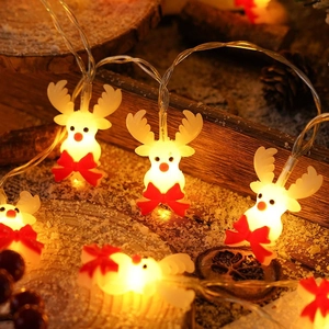 Warm LED Christmas reindeer string lights with red bows on a cozy winter backdrop