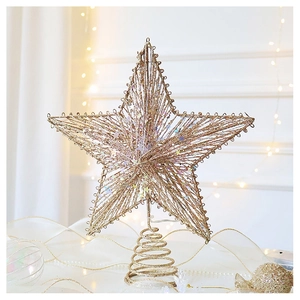 Macro detail of champagne gold glittery star tree topper with spiral spring base stand
