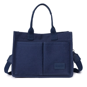 Japanese style dark blue canvas tote bag with dual pockets and adjustable shoulder strap