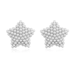 Macro shot of star-shaped stud earrings made of elegant white pearls on a white surface