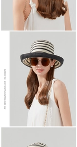 Detailed view of the woven black and white striped straw sun hat with stylish texture
