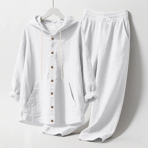 Close-up of white linen texture and brown button details on a men's beach set