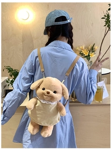 Detail of cute brown plush dog backpack with yellow outfit worn in a cafe setting