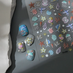 Detailed view of 5D ocean embossed nail stickers with seahorse and jellyfish motifs