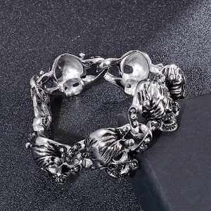 Detailed view of punk style skull link bracelet with vintage oxidized finish for men