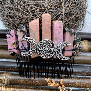 Detail of bohemian hair comb with natural pink stones and silver crescent moon over a nest