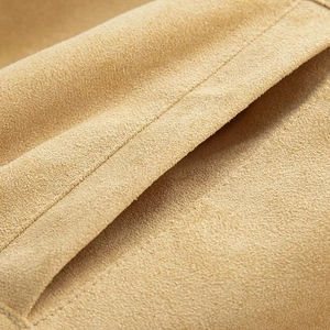 Macro shot of premium khaki suede material with fine stitching details on the jacket