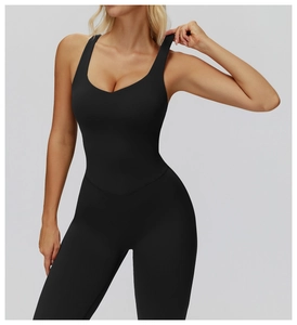 Detail of black flared yoga jumpsuit with deep U-neck and V-shaped abdominal stitching