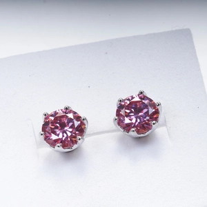Macro shot of 1ct pink moissanite earrings with six-prong silver setting details