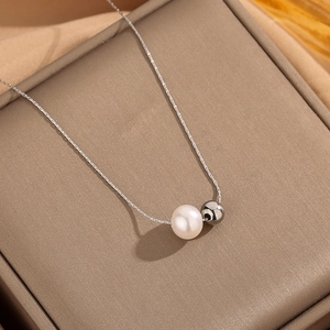 French vintage titanium steel necklace with pearl and metal ball pendant on jewelry box