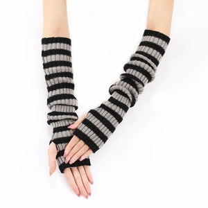 Detail of black and grey striped knitted arm warmers with a fingerless thumb hole design