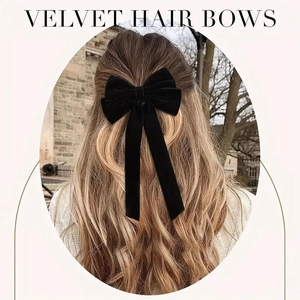 Elegant black velvet double bow hair clip with long ribbons worn by a model