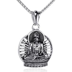Macro shot of silver Buddha pendant on lotus seat with detailed engraving and box chain