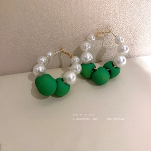 Elegant C-shaped pearl hoop earrings with green velvet beads in gold-toned setting