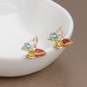 Elegant gold butterfly stud earrings with colorful zircon crystals on a white pedestal