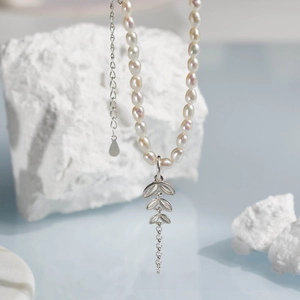 Detail view of natural freshwater pearl necklace with elegant silver leaf pendant charm