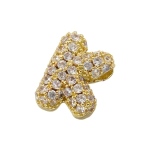 Macro shot of 5A cubic zirconia stones on a gold-plated bubble letter K pendant detail