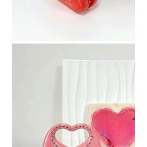Detail of stone pattern heart-shaped handle with rhinestones on acrylic crossbody bag